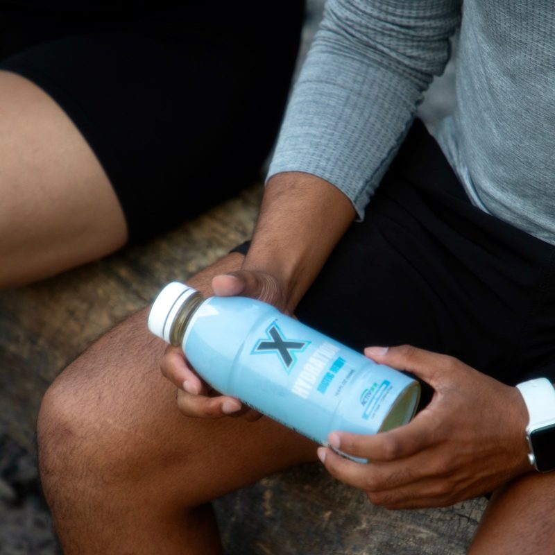 Holding an Arctic Berry® bottle